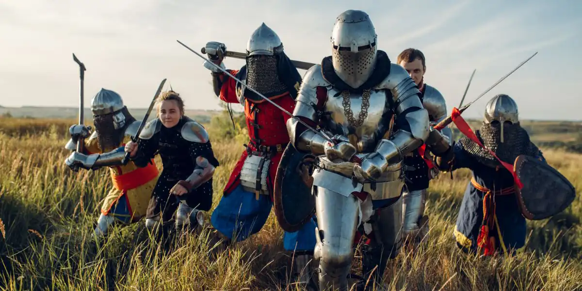 Larp players in armour charging through a field