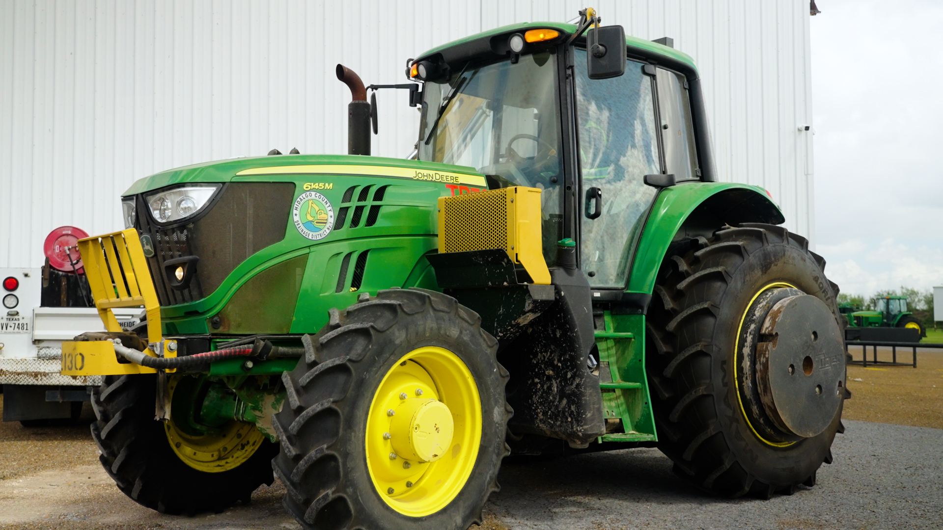 A John Deere tractor sits in a dealer lot at Tellus Equipment in Texas.