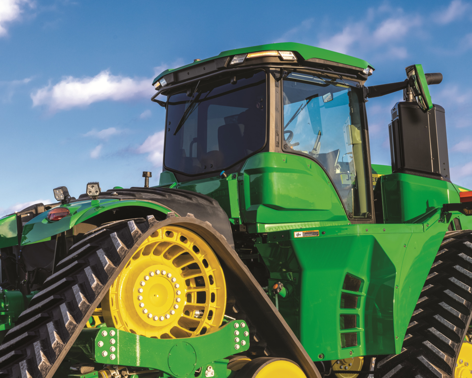 A close up shot of a John Deere 9RX tractor.
