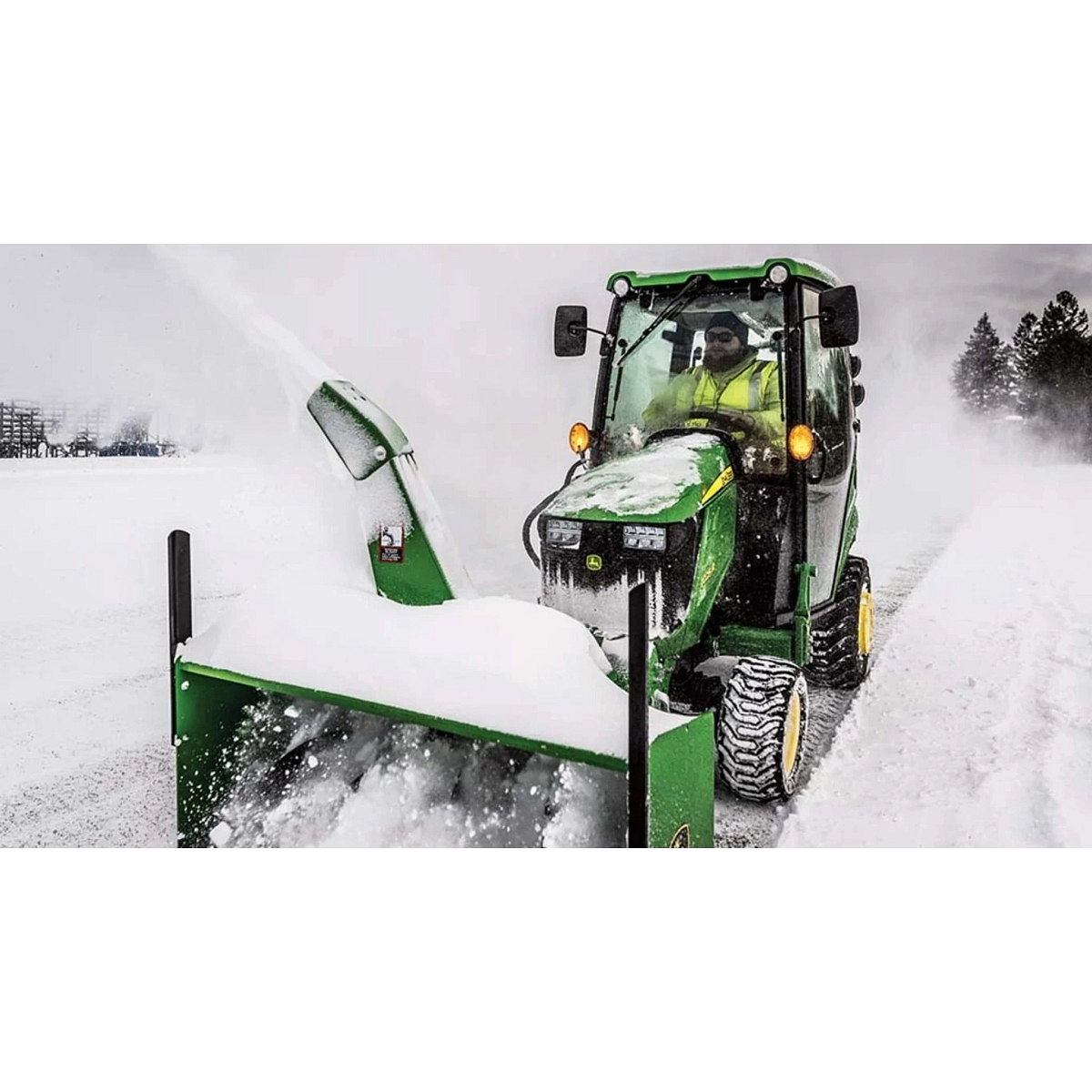 1025R Tractor Sub-Compact Tractors with a tractor with a snow blower in the snow