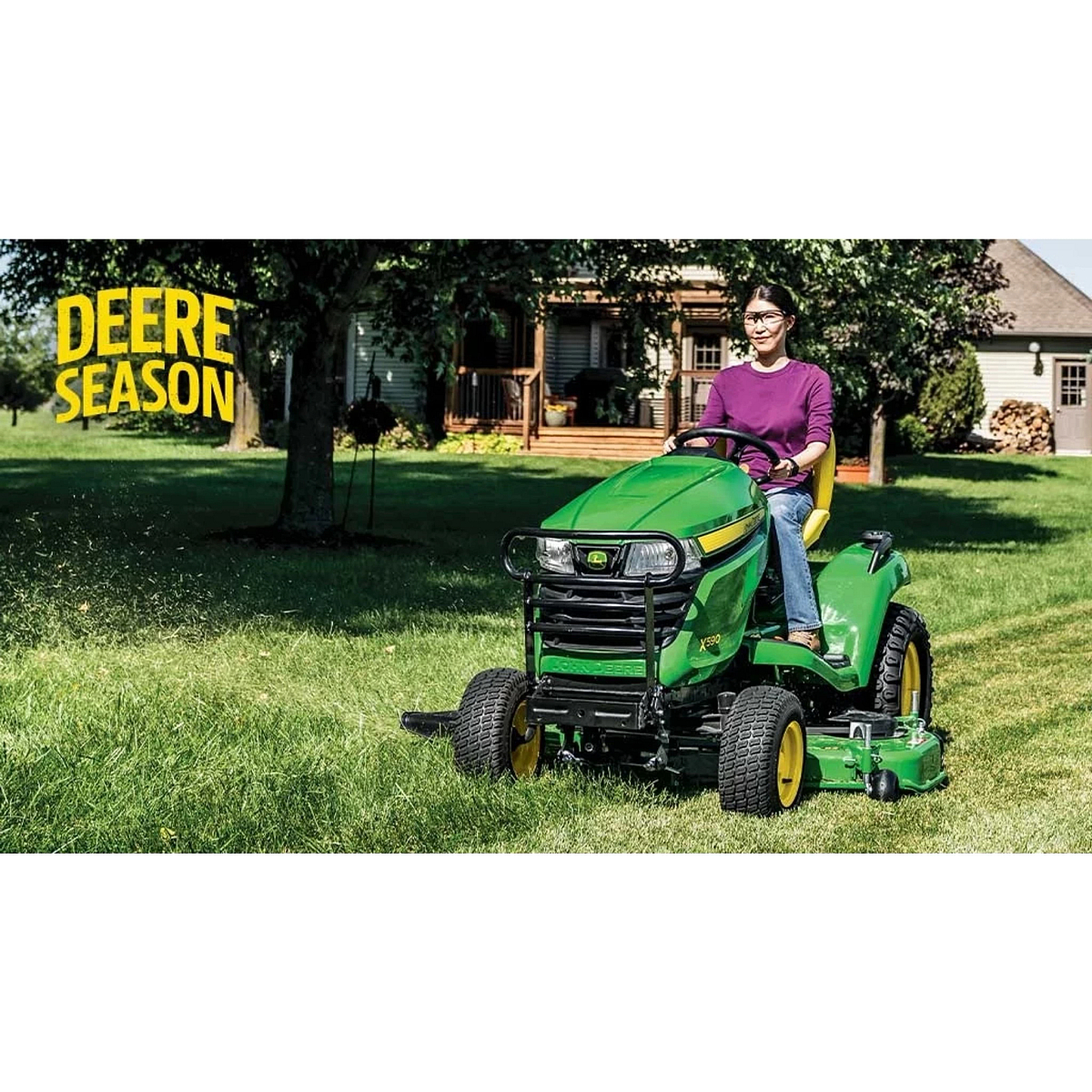 Homeowner mowing her yard with an X590 Mower with the words "Deere Season"