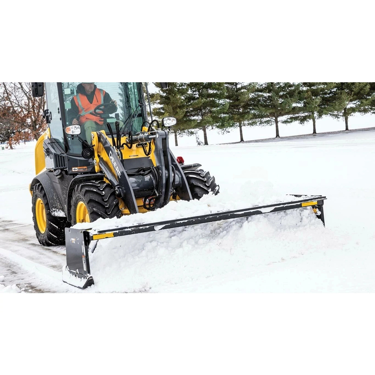 224L Wheel Loader with an SP10C Snow Pusher Attachment pushing snow in a parking lot