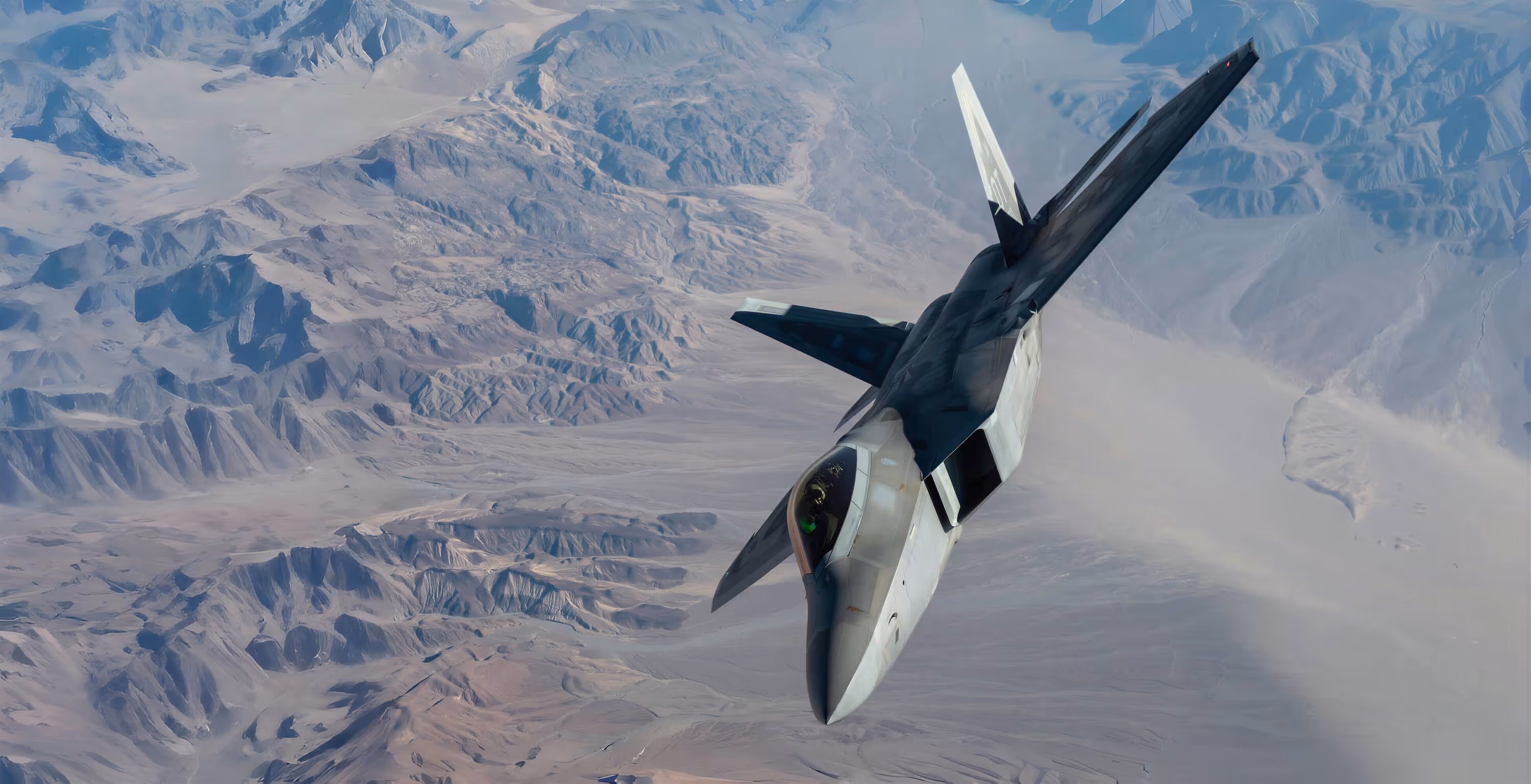 F22 flying over arid desert