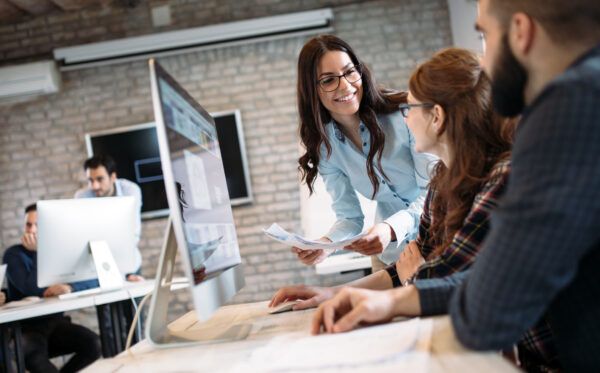 Young professionals working on project in office together