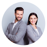 Smiling man and woman standing back to back with arms crossed against a light gray background.