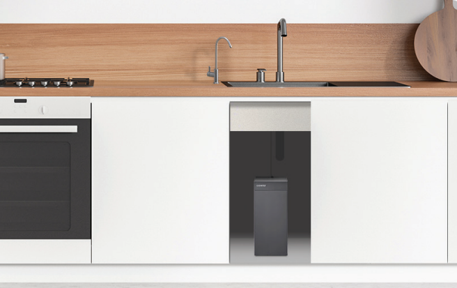 Modern kitchen with white cabinets, wooden backsplash, black built-in oven, stainless steel sink, and a black Coway P-2211N water purifier installed under the sink.