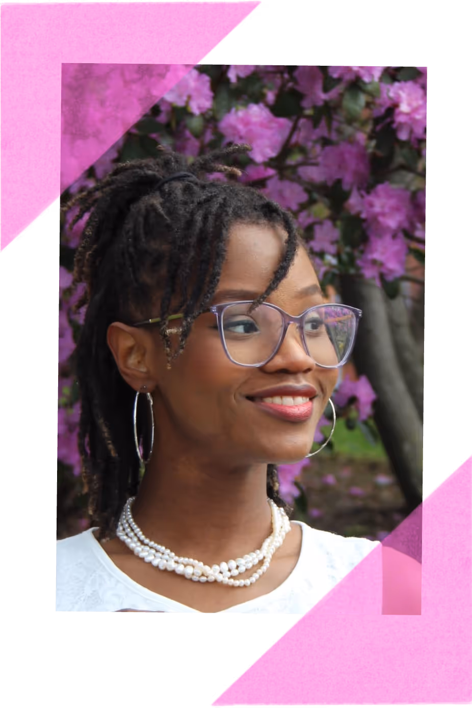The developer, a smiling woman with dreadlocks wearing glasses, hoop earrings, and layered pearl necklaces, standing outdoors with pink flowers in the background.