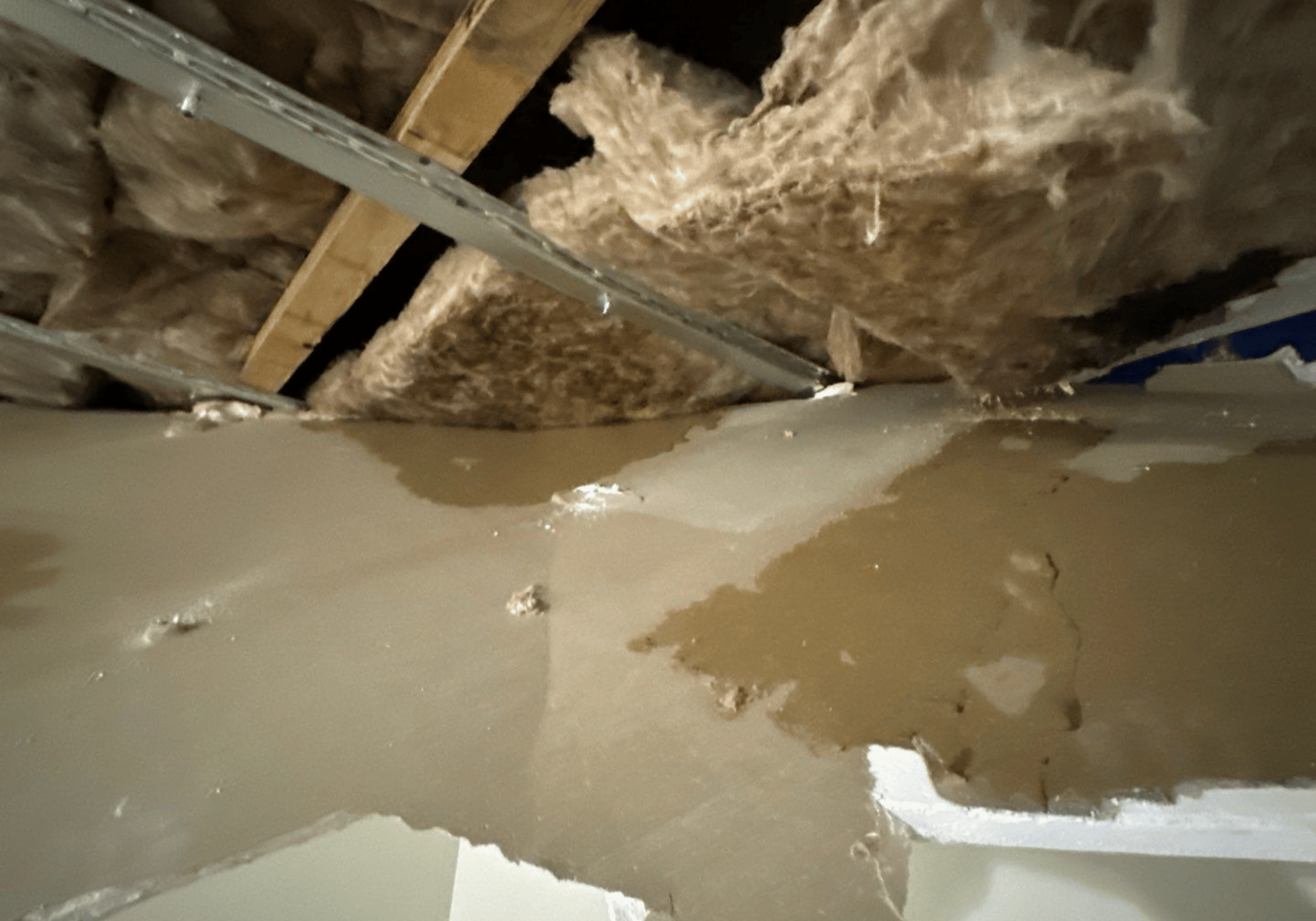 Ceiling leak and insulation damage requiring professional water damage restoration Calgary services