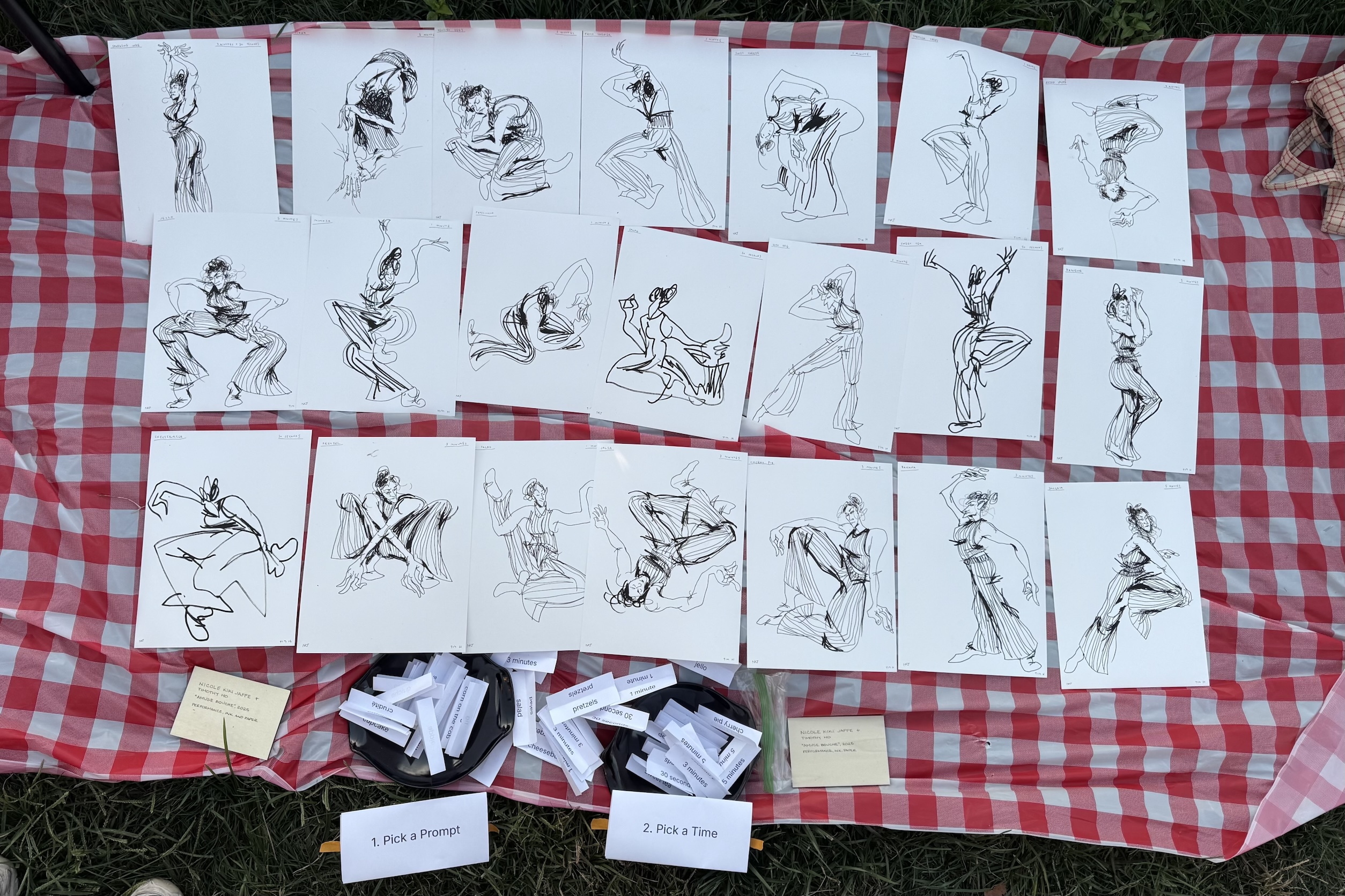 Ink sketches of expressive dancing figures displayed on a red-and-white checkered cloth, with containers holding prompt and time choice slips.