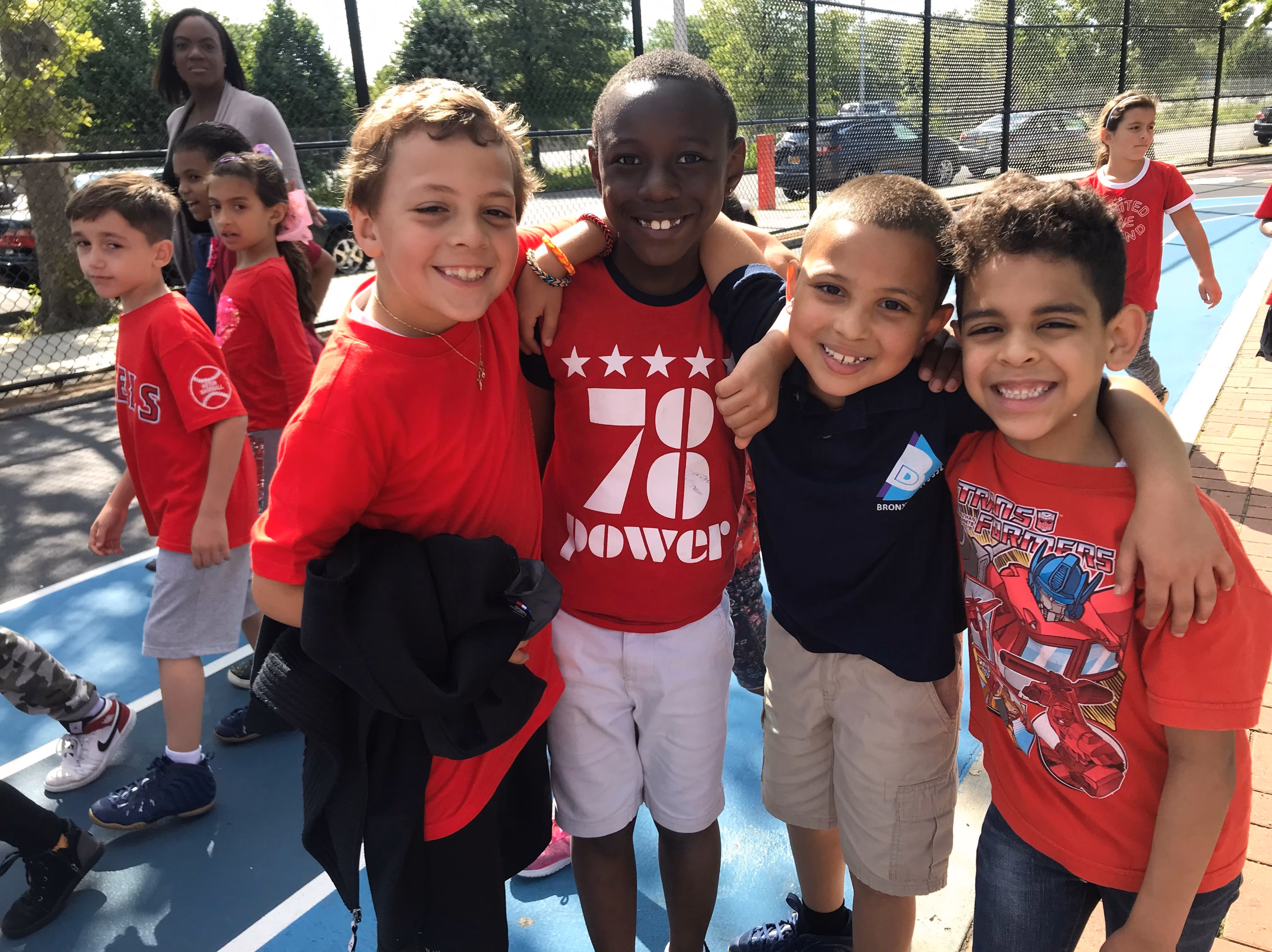 Group of students smiling together in the schoolyard