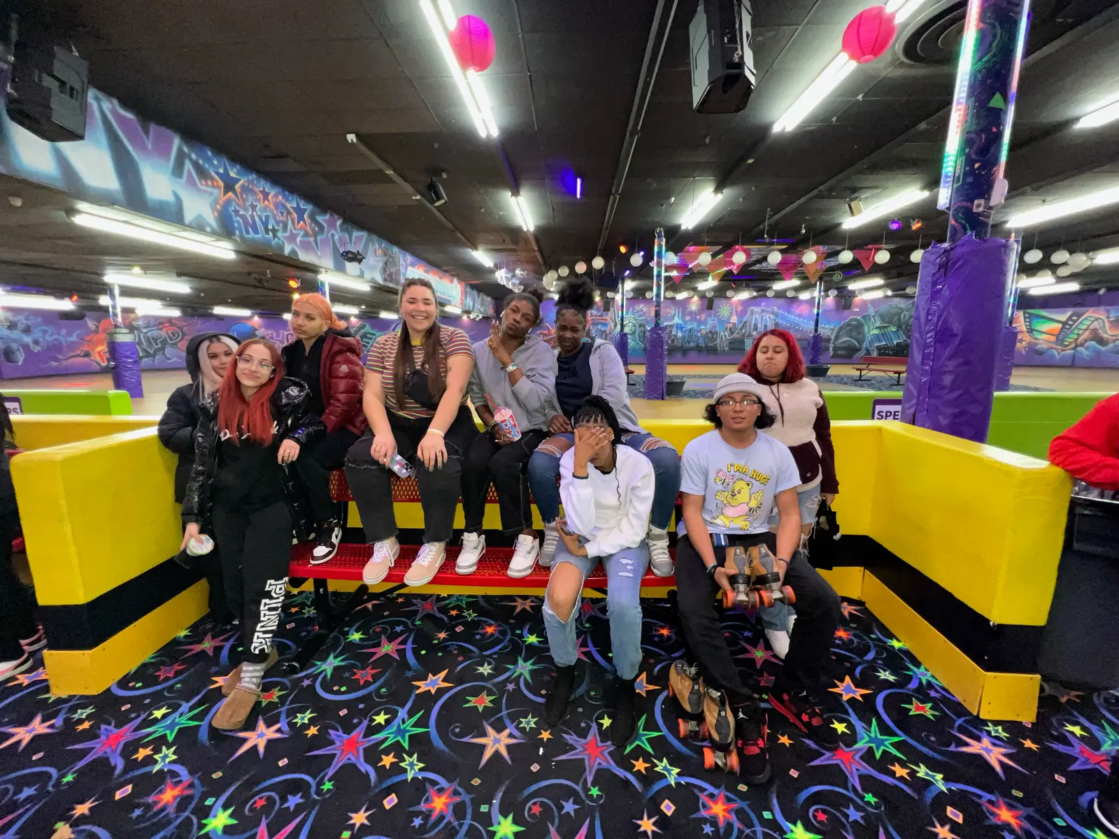 Students posing together at a roller skating rink field trip