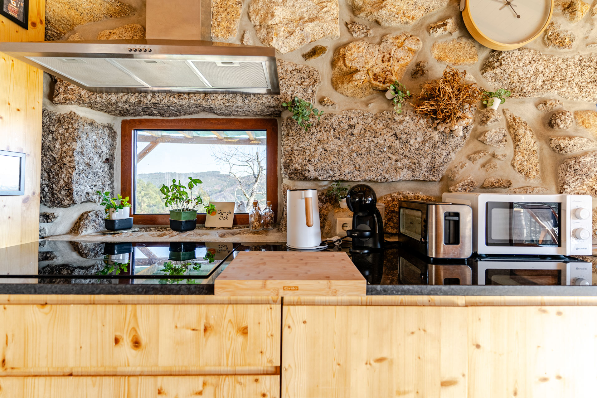 Three young professionals in a minimalistic office, two women and one man, working around two iMac computers on a white desk.
