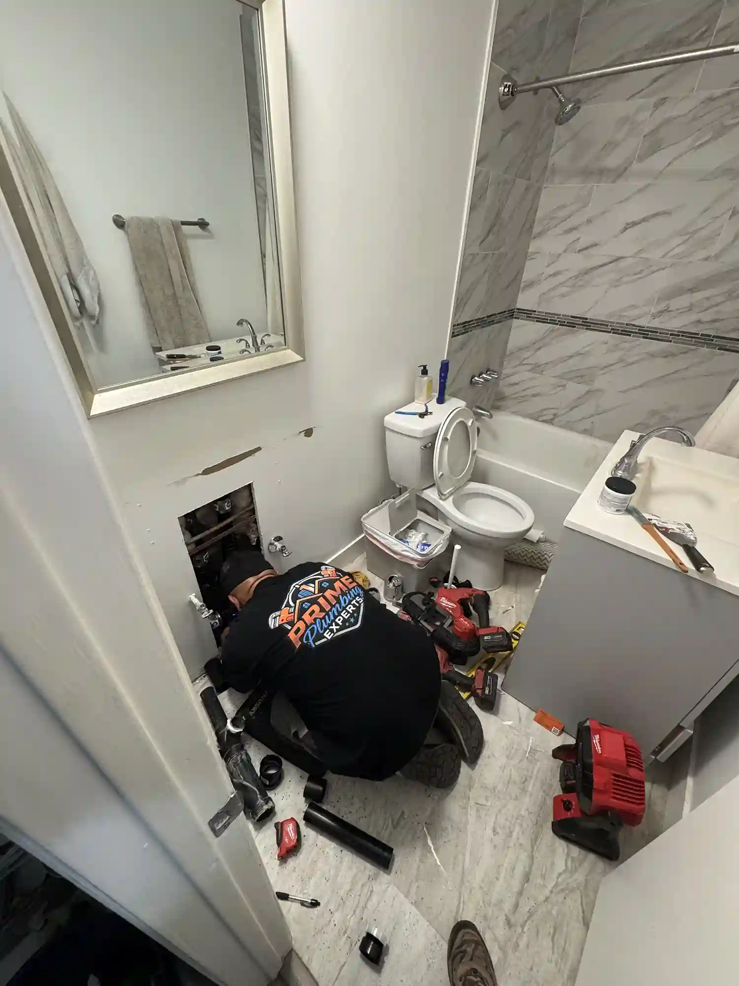 Prime Plumbing technician performing emergency bathroom pipe repair in a Yucaipa residence.