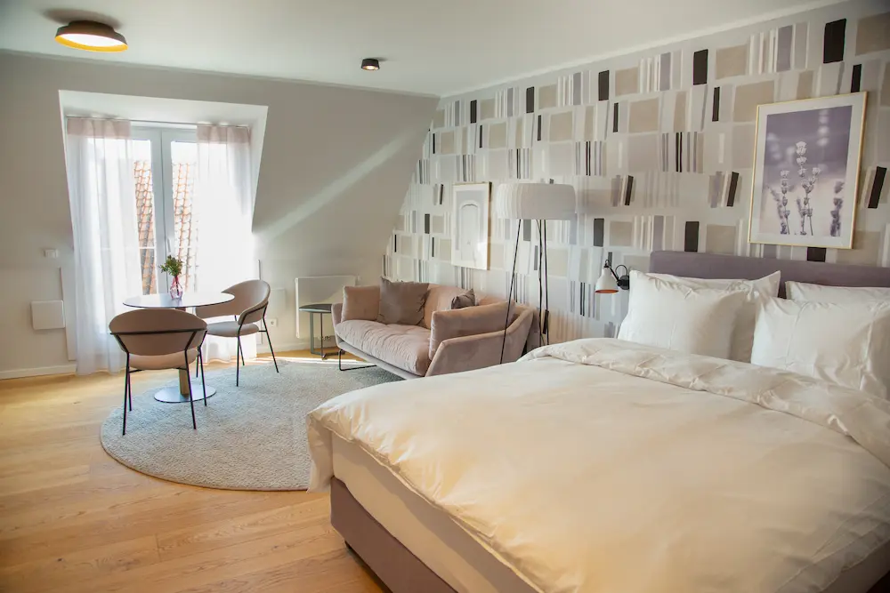 Schlafbereich mit floralem Muster im Deluxe Studio, 21rooms Ingolstadt