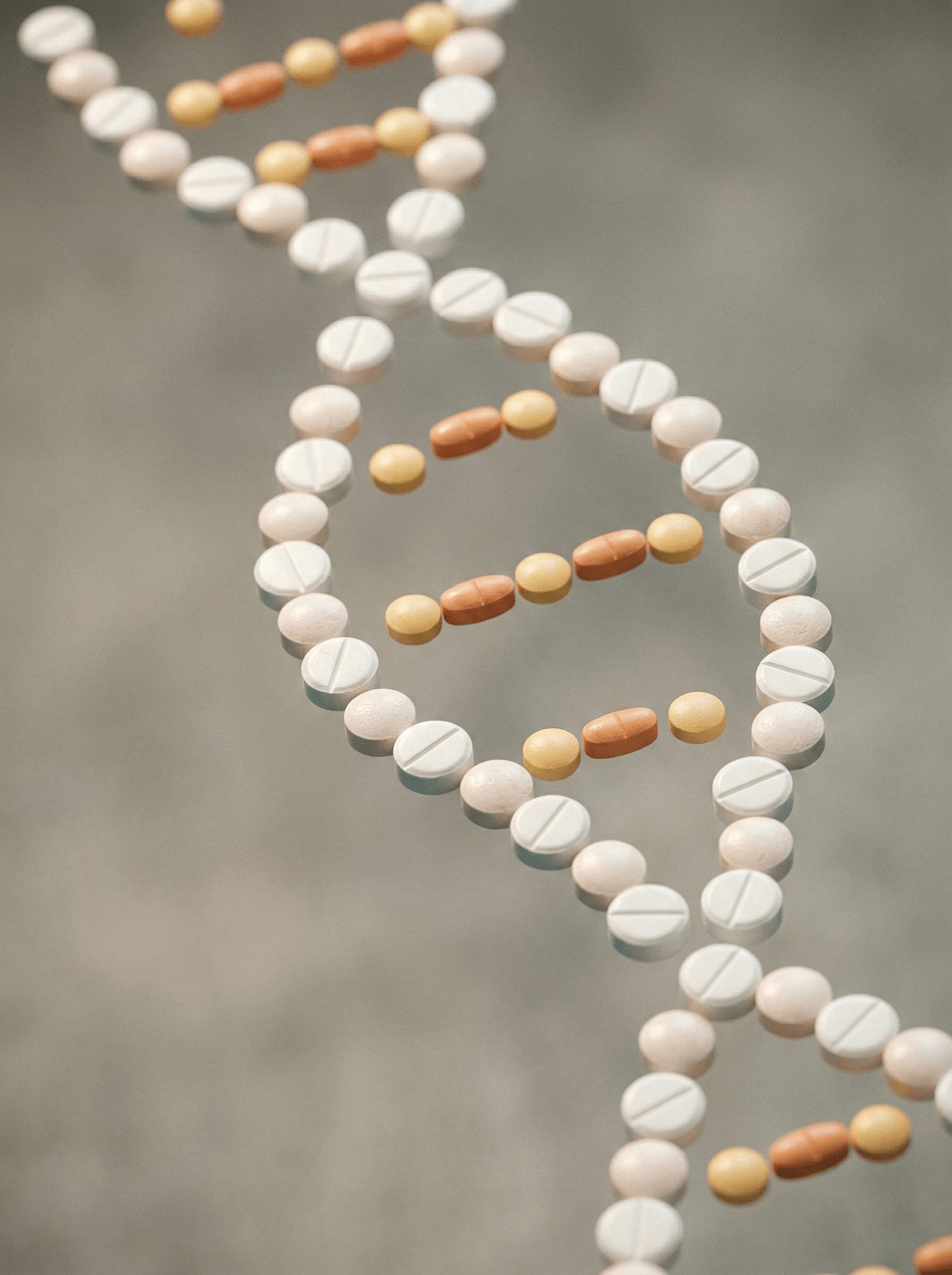 DNA-spiral formad av vita, gula och orange piller mot grå bakgrund.