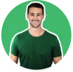 Smiling young man wearing a dark green T-shirt against a green circular background.
