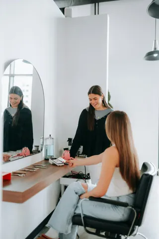 A salon professional caring for a client