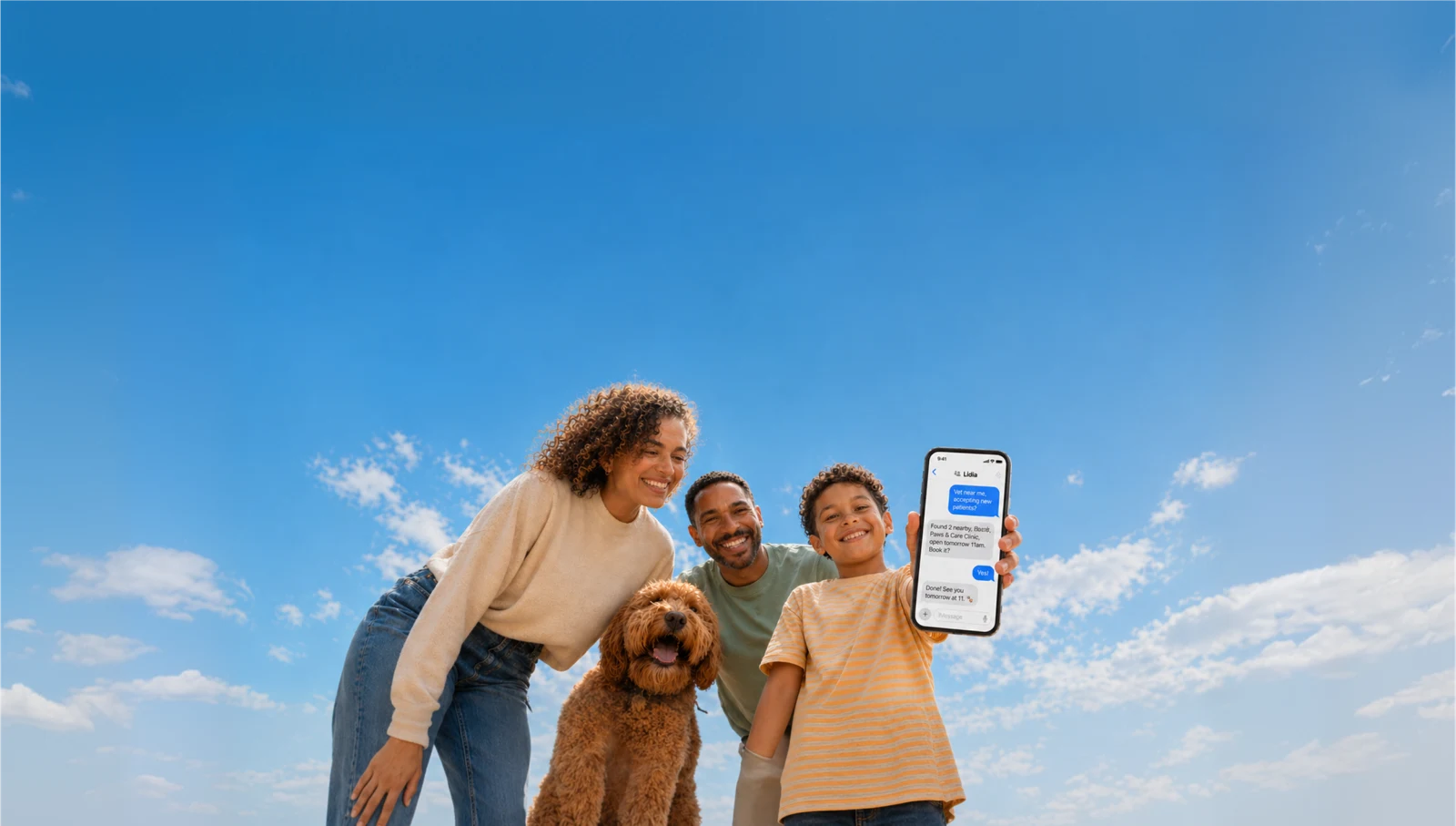 A family with their child and dog, holding a phone under a blue sky