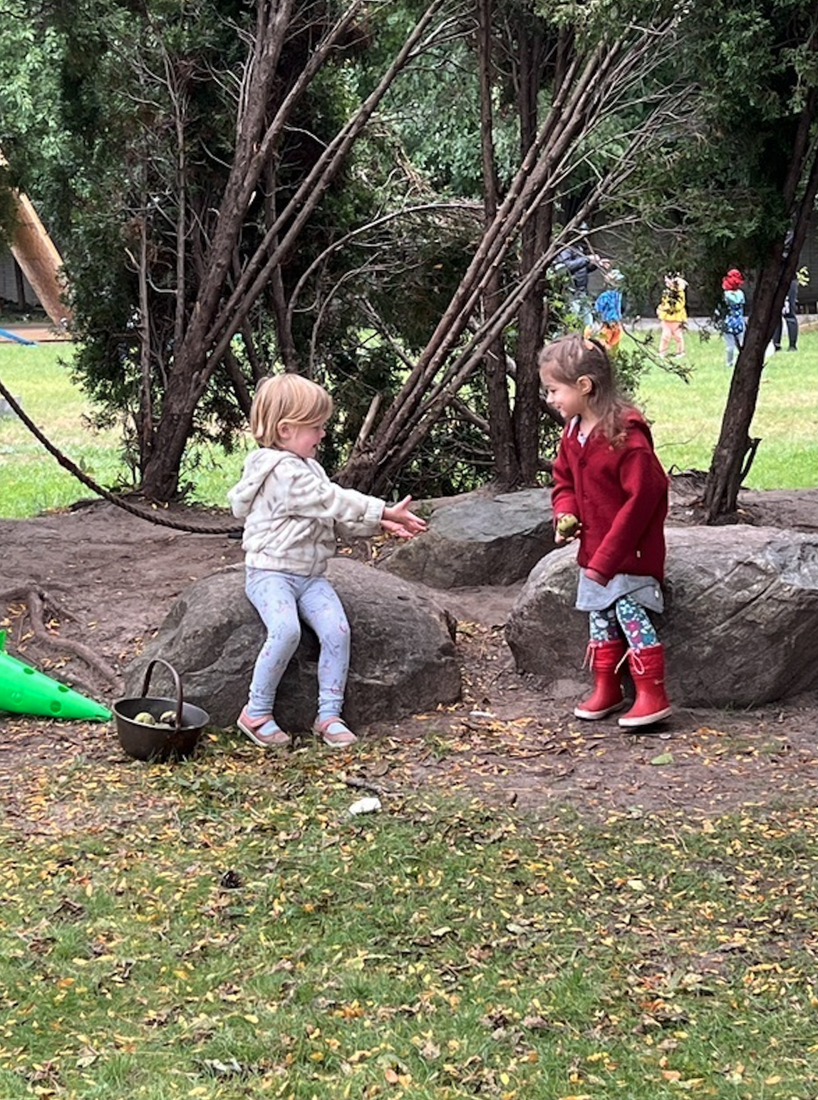 Children playing outdoors in nature area at Marvelous Child Preschool in Michigan