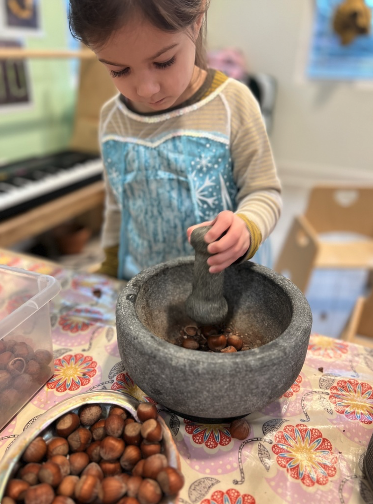 Child exploring natural materials through hands-on learning at Marvelous Child Preschool