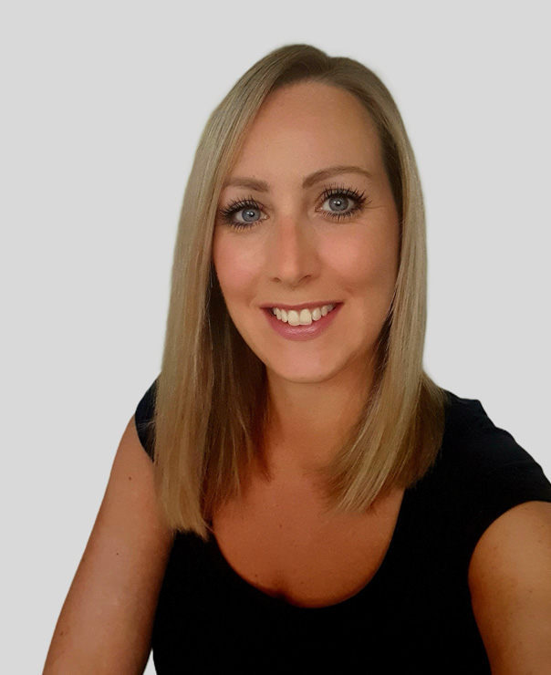 Smiling woman with straight blonde hair, wearing a black shirt, and light gray background.