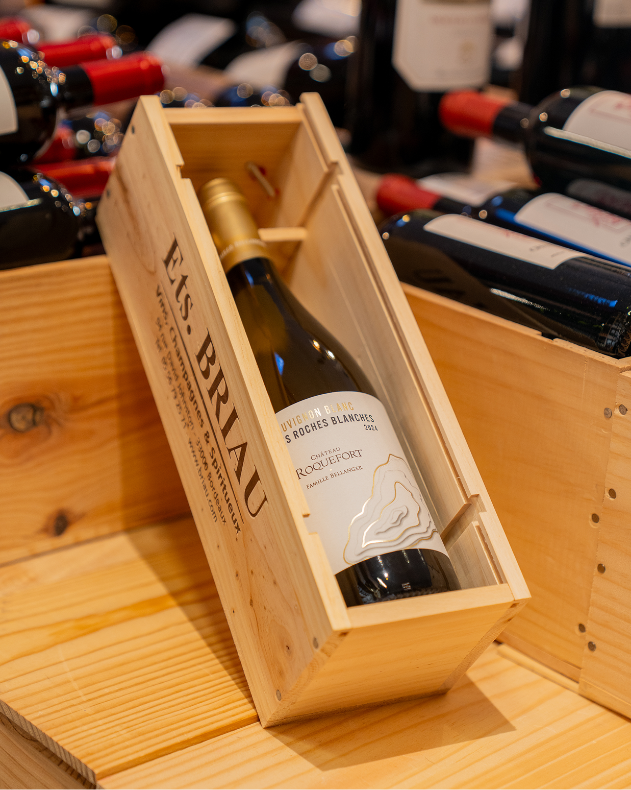 A bottle of white wine in a wine case