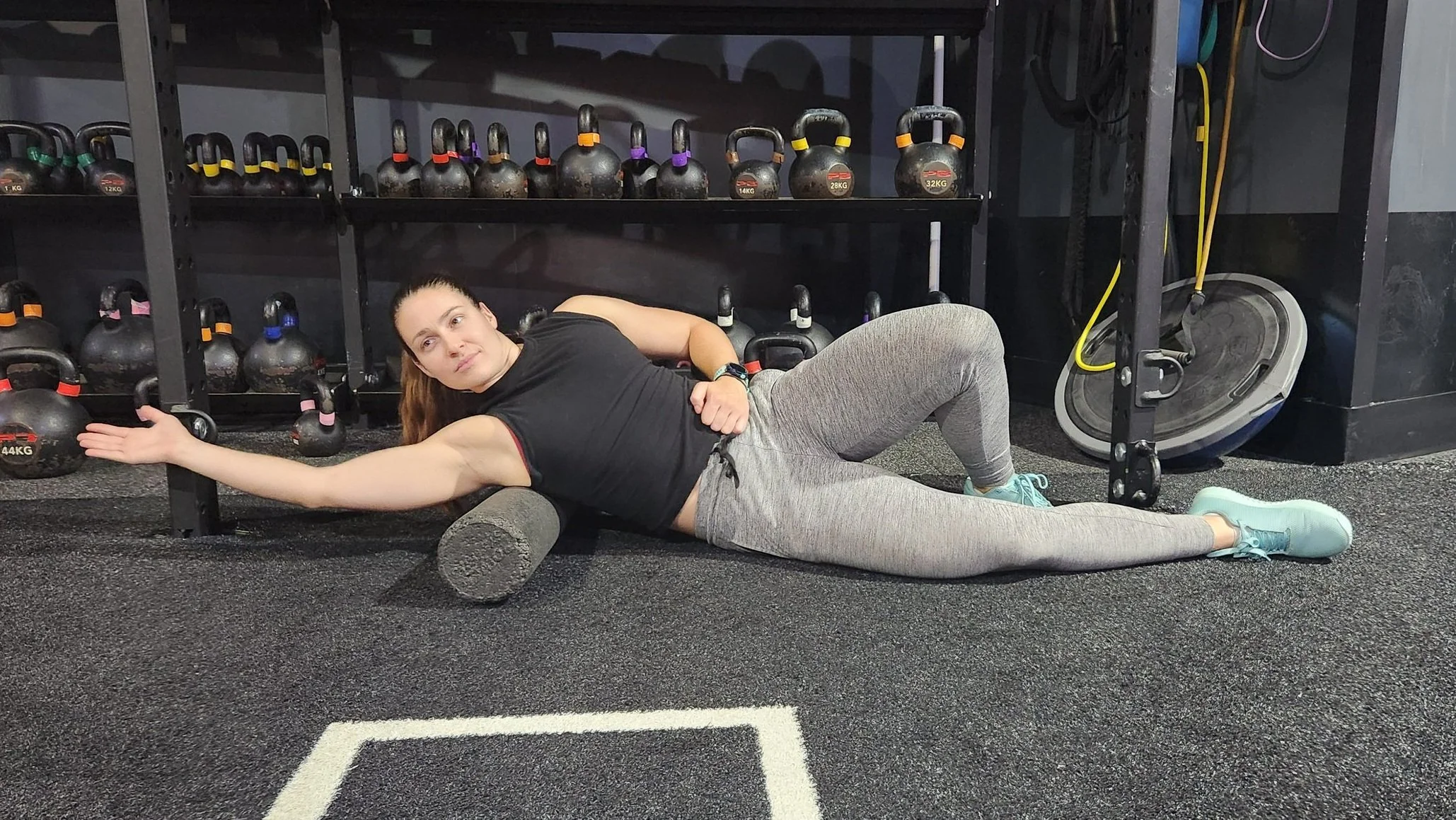 Person foam rolling their lats for muscle recovery