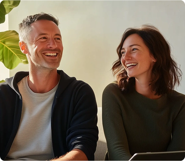 A man and woman laughing during a discussion.