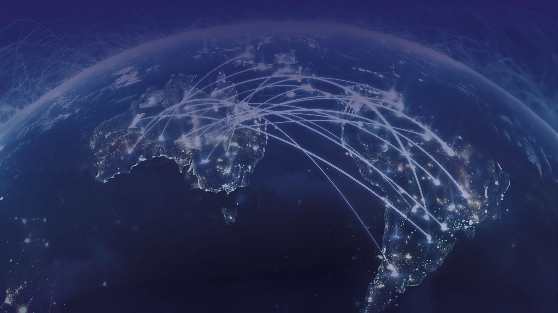 Night view of Earth from space showing illuminated cities and white lines representing global network connections across continents.