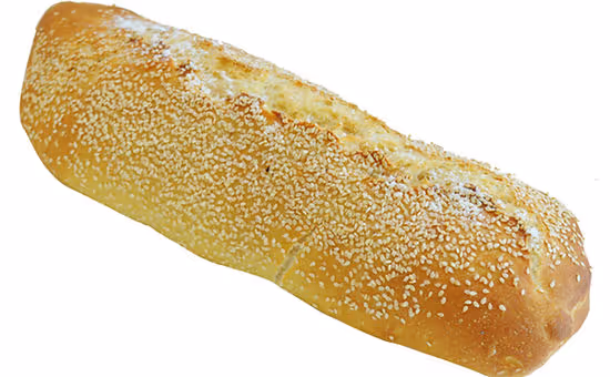 Loaf of golden bread topped with sesame seeds on a white background.