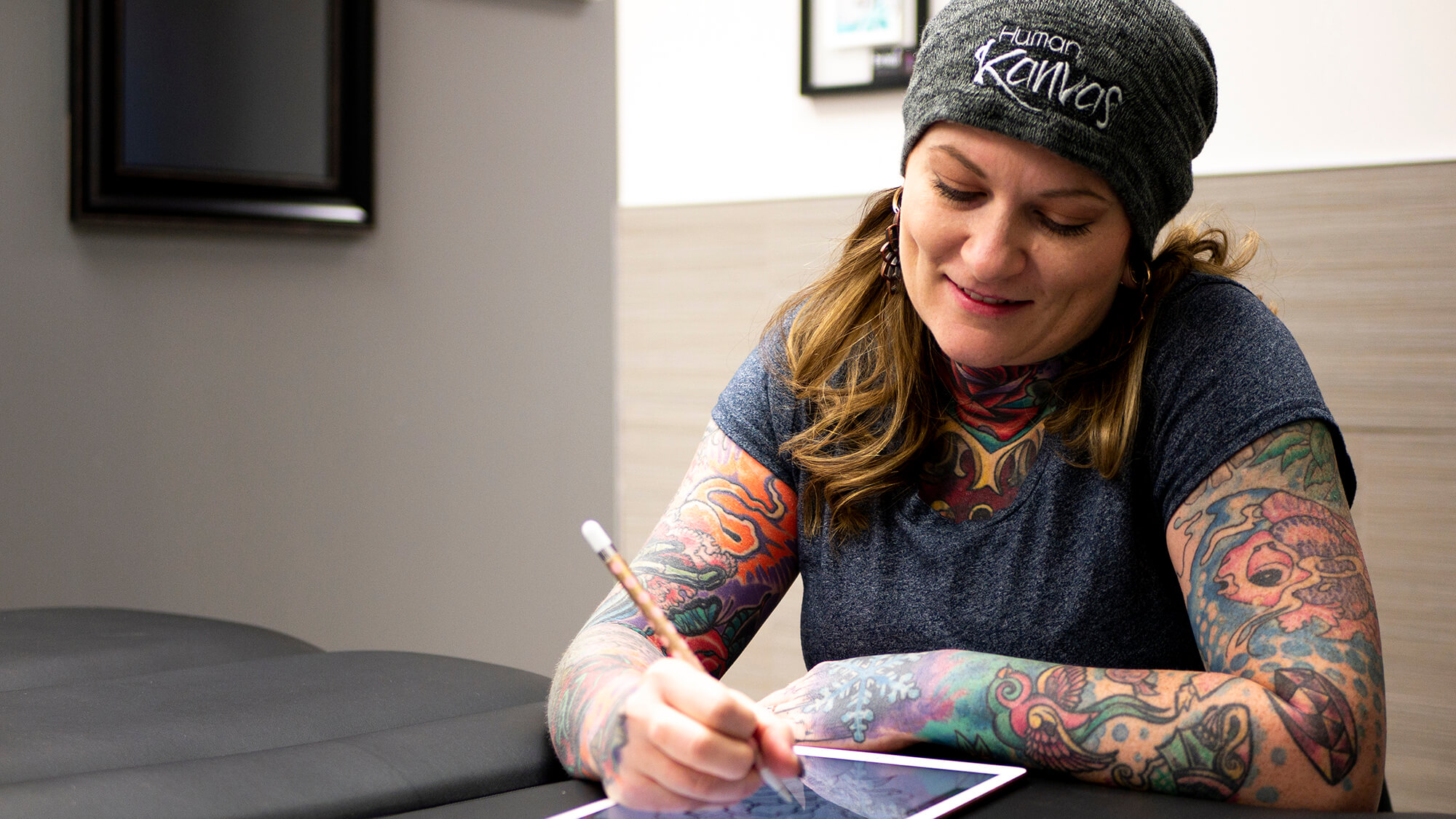 Human Kanvas founder, owner, operator and Tattoo Artist Brandi Lee working on a client design