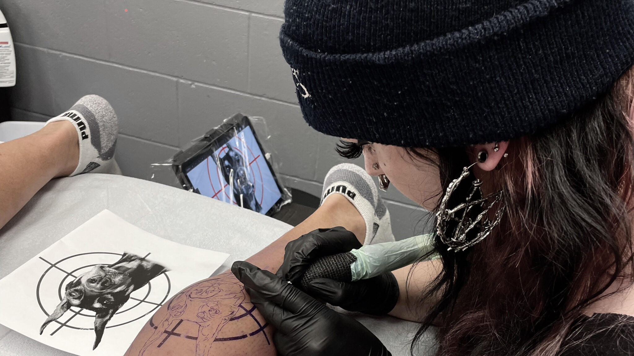 Human Kanvas Tattoo Artist Ash working on a tattoo
