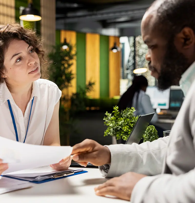 two professionals discussing some paperwork
