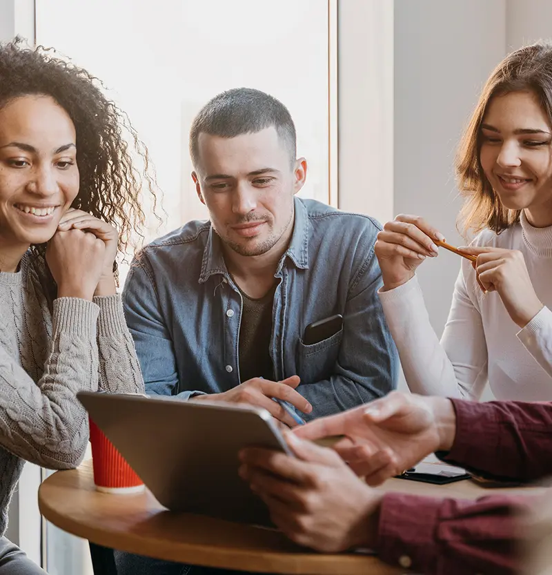 group of happy employees gathered around a table