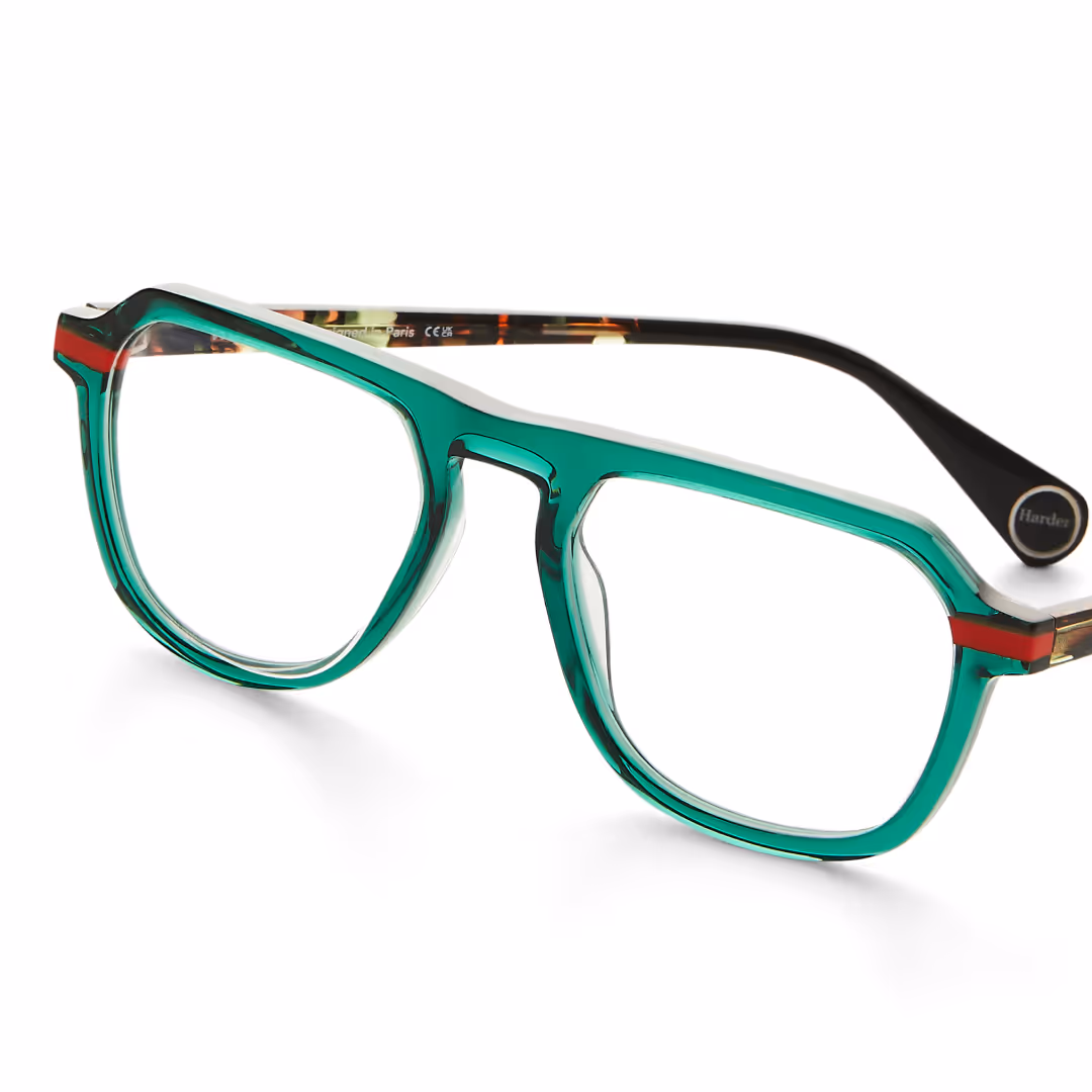 Transparent green eyeglasses with red and black accents on white background