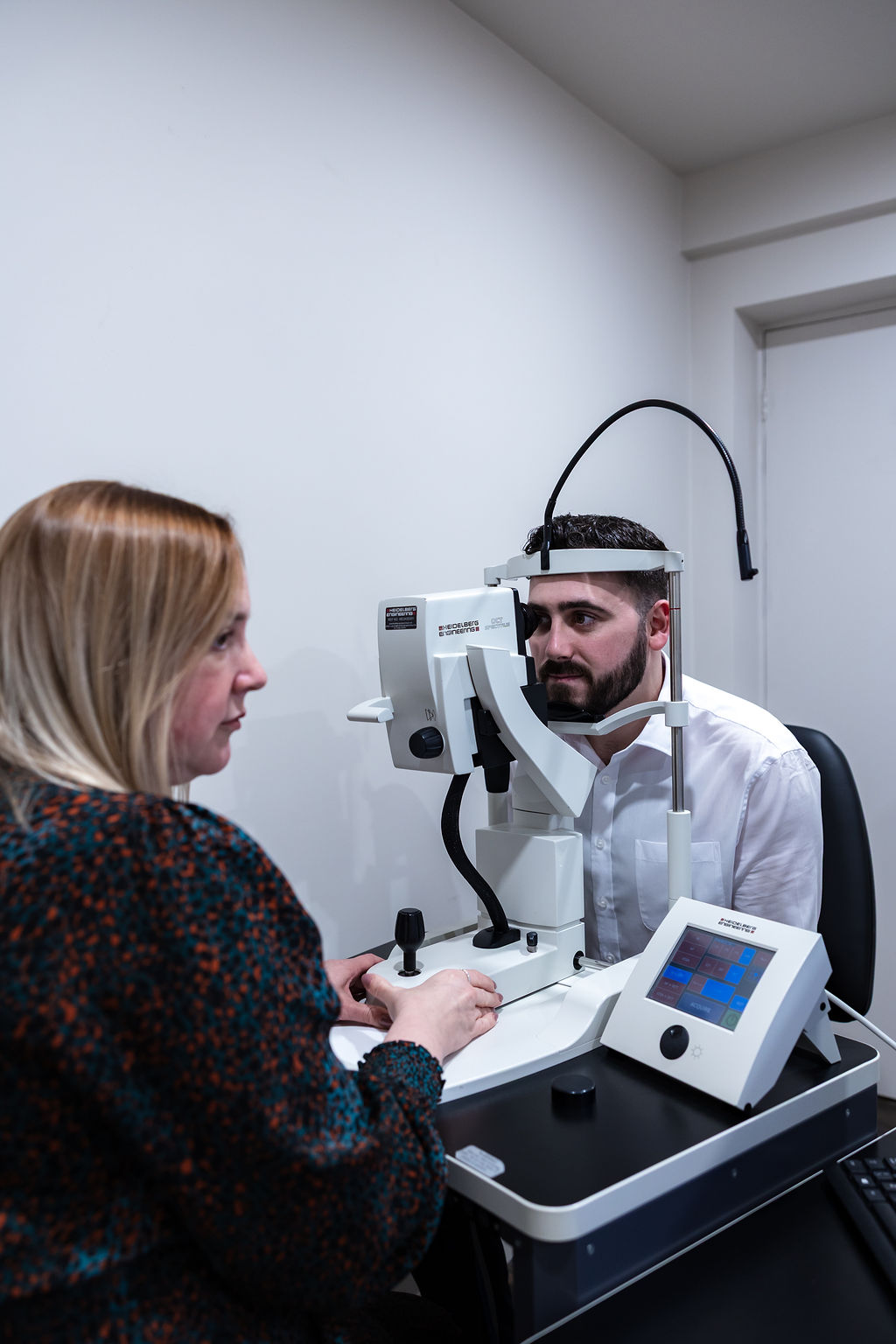 Eye examination with professional using advanced optical diagnostic equipment