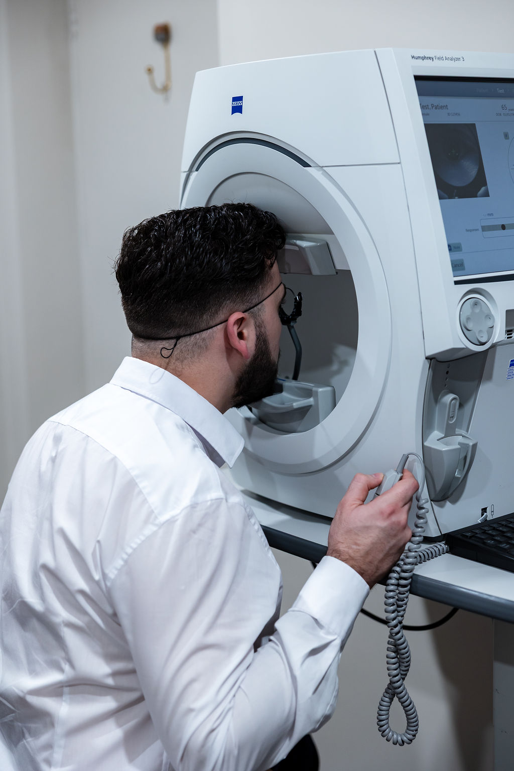 Medical professional operating Zeiss medical imaging scanner in clinic