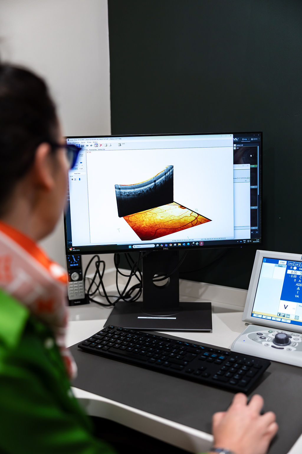 Medical professional analyzing eye scan on computer screen