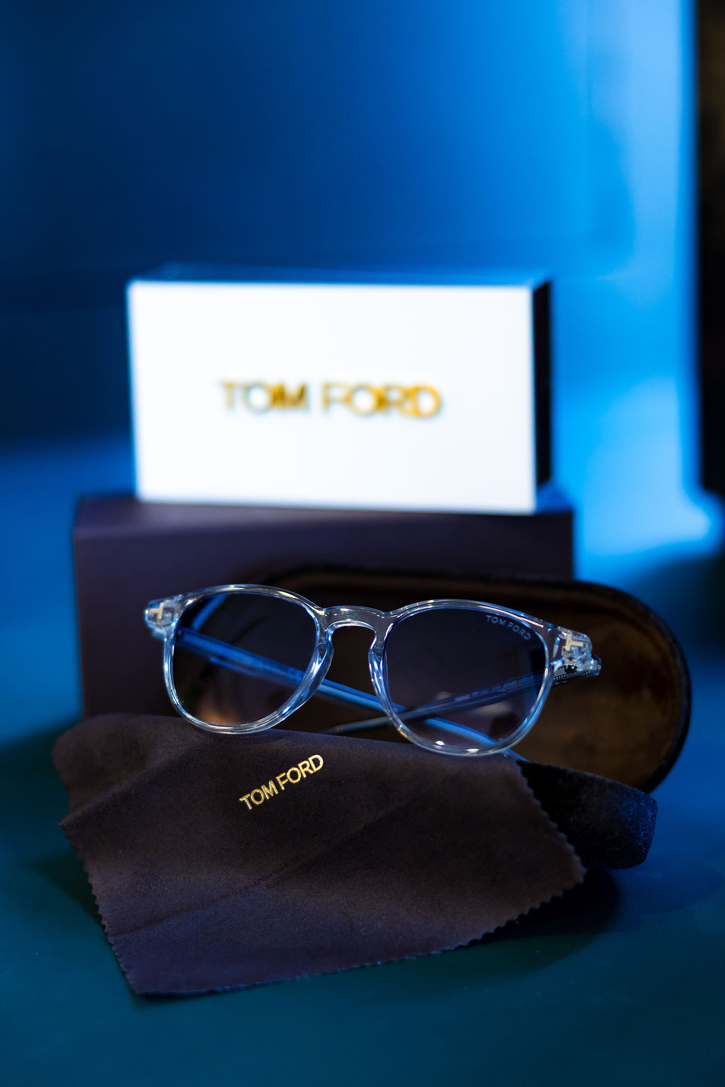 Transparent Tom Ford eyeglasses on black cloth with brand card