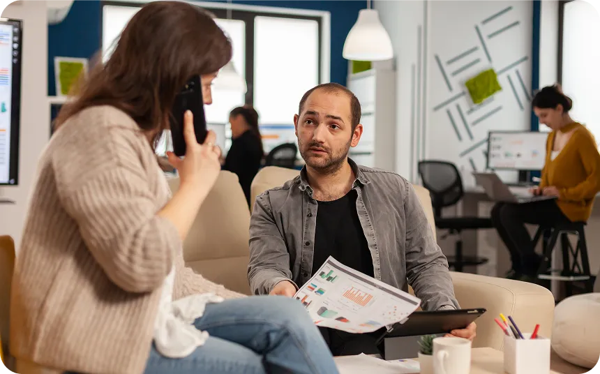 Wind turbines standing in a green field under a partly cloudy sky.
