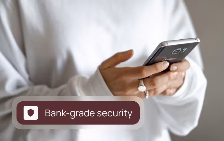 Person holding a smartphone with a graphic label stating 'Bank-grade security'.