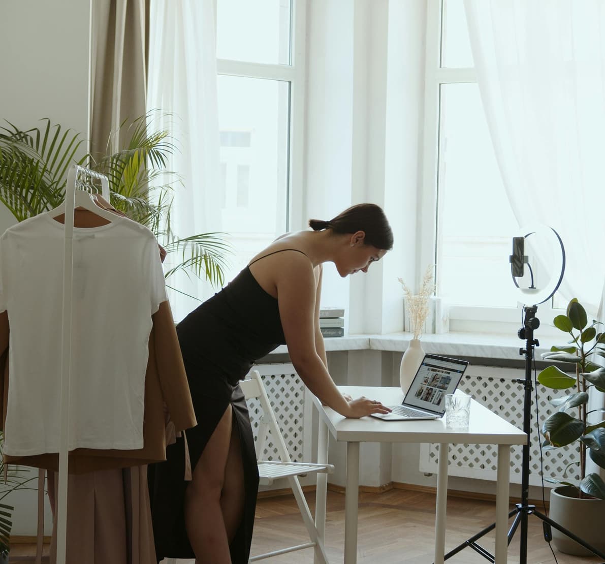 girl in a living room with filming equipment and a computer
