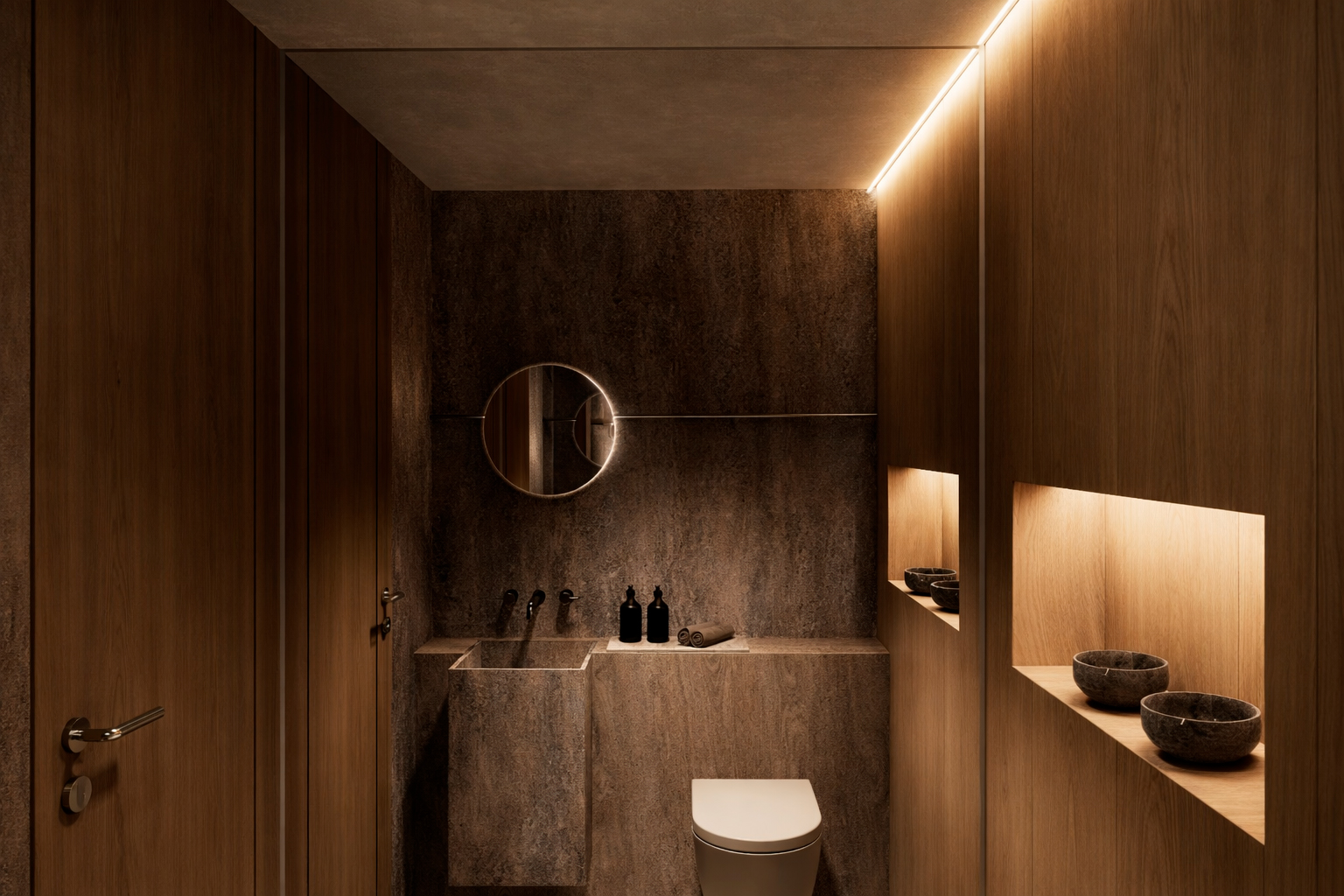 Modern bathroom with dark stone walls, a circular backlit mirror, a wall-mounted toilet, and recessed wooden shelves with stone bowls.
