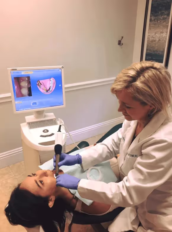 A dentist scanning a patient's mouth