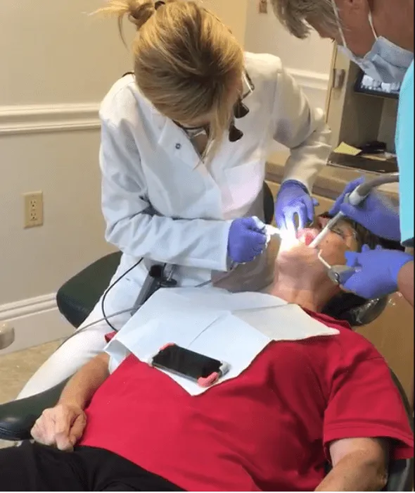 Dr. Ilona performing dental treatment on patient