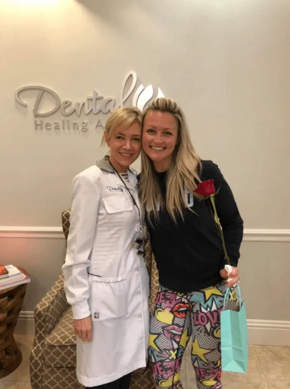 Dentist and patient smiling together