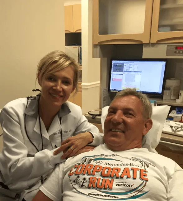 Dentist and patient smiling for the camera