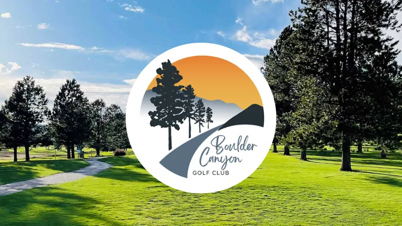 Green golf course with trees under a blue sky, overlaid by the Boulder Canyon Golf Club logo featuring silhouettes of trees, a winding path, and mountains against an orange sunset background.