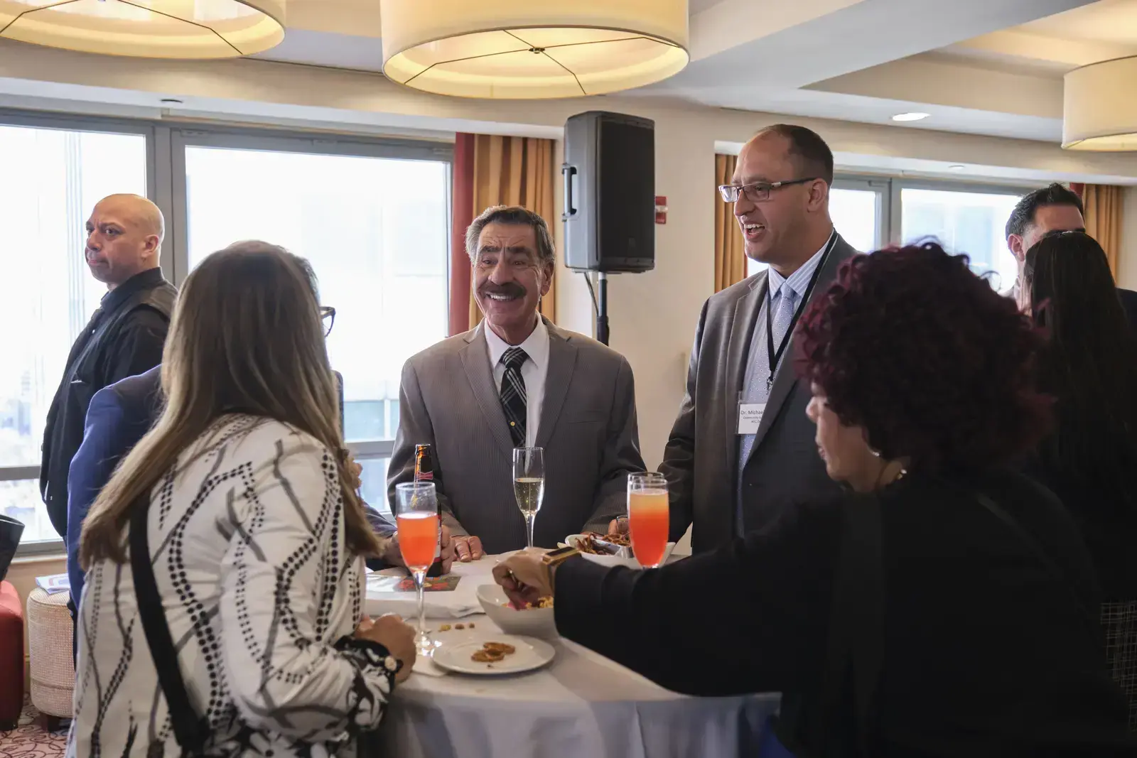 Faculty and staff networking at school reception event