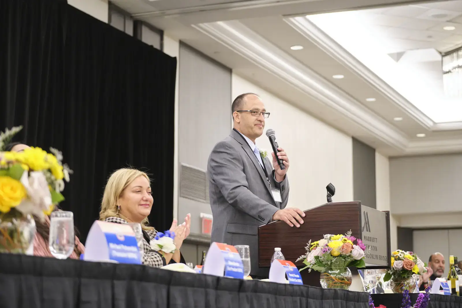 Speaker addressing audience at school event podium